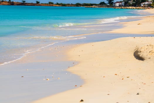 Caribbean beach with white sand, deep blue sky and turquoise water