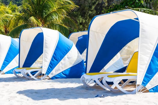 Umbrellas and sunbeds by the exotic tropical beach, Haiti, Caribbean Sea