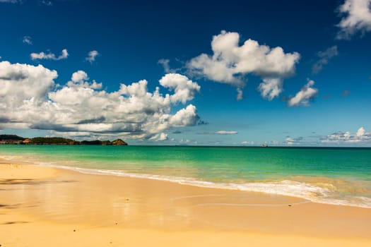 Caribbean beach with white sand, deep blue sky and turquoise water