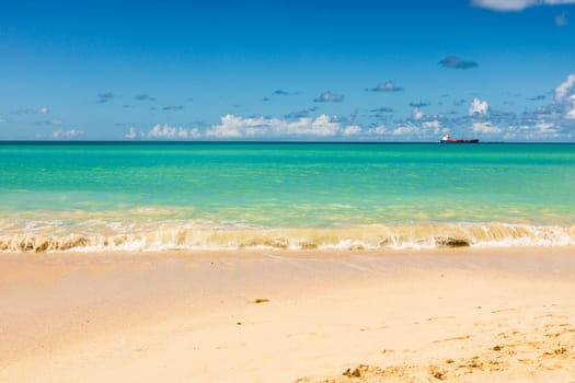 Caribbean beach with white sand, deep blue sky and turquoise water