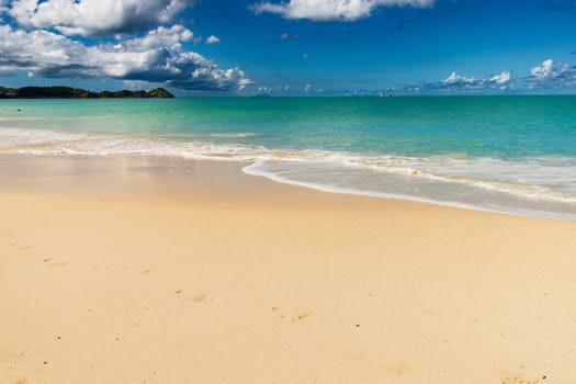 Caribbean beach with white sand, deep blue sky and turquoise water