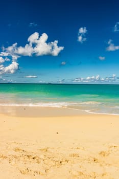 Caribbean beach with white sand, deep blue sky and turquoise water