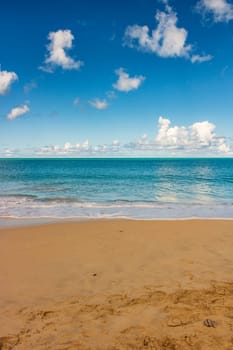 Caribbean beach with white sand, deep blue sky and turquoise water