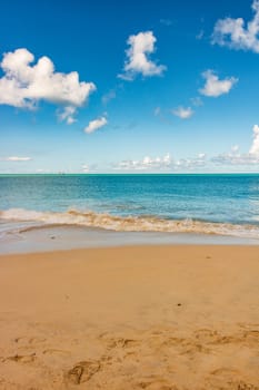 Caribbean beach with white sand, deep blue sky and turquoise water