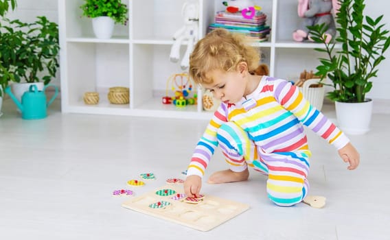 Child learns numbers game logic. Selective focus. Baby.