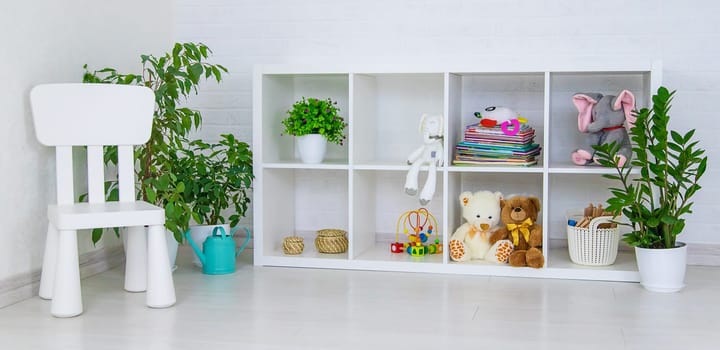 Children's shelf in the room with toys. Selective focus. Kid.