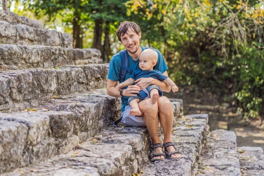 Dad and son tourists at Coba, Mexico. Ancient mayan city in Mexico. Coba is an archaeological area and a famous landmark of Yucatan Peninsula. Cloudy sky over a pyramid in Mexico.