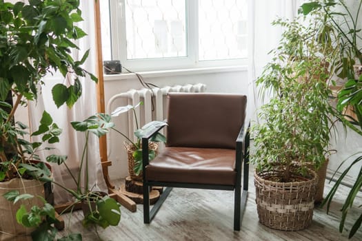 A fragment of the interior with a variety of indoor plants and plaster sculptures. Urban jungle concept. Biophilia design.