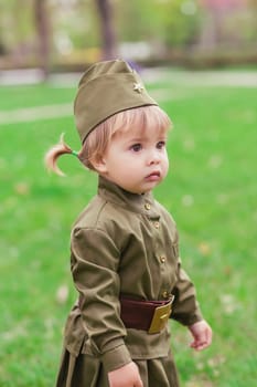 Adorable baby girl in Soviet military uniform.