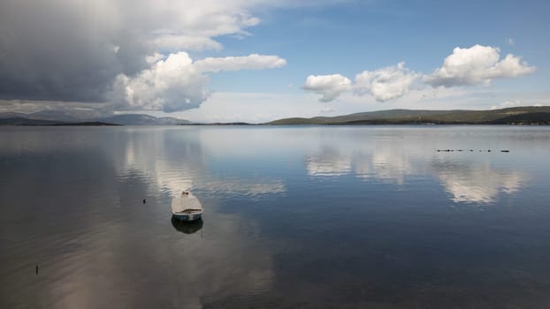 A small boat at beach of Urla, izmir. beautiful clouds