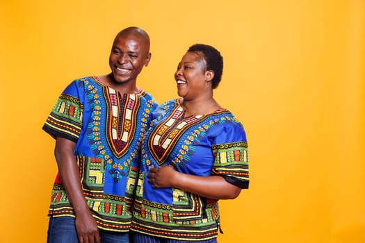 Smiling happy man and woman romantic couple laughing and looking at camera. Mid adult boyfriend and girlfriend having fun together with cheerful expression while posing for portrait