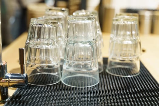 Close-up view of multiple glasses arranged neatly on a table.