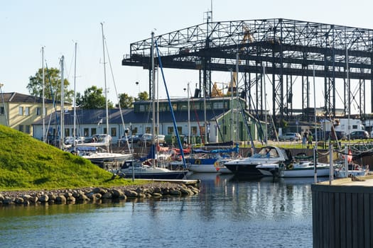 Klaipeda, Lithuania - August 11, 2023: Several boats of different sizes floating in the calm water, under a clear sky.