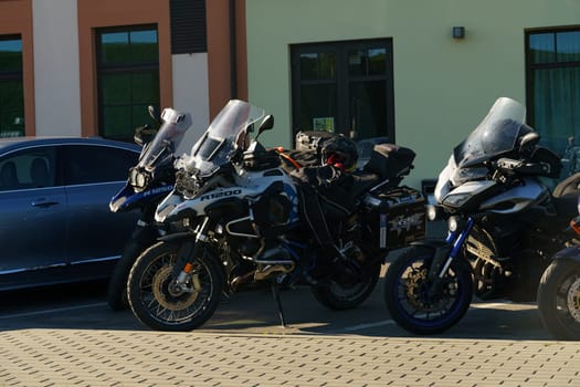 Klaipeda, Lithuania - August 11, 2023: A collection of motorcycles parked in a row next to each other in a designated parking area.