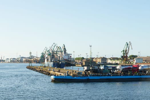 Klaipeda, Lithuania - August 11, 2023: A sizable blue boat peacefully drifts on the calm water surface.