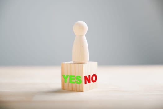 People on wood show right and wrong thinking yes or no. True or false symbols for business choices. Decision-making concept depicted on wooden cube block. Think With Yes Or No Choice.