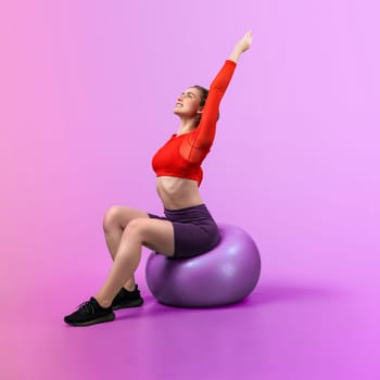 Full body length gaiety shot athletic and sporty young woman with fitness exercising ball in standing posture on isolated background. Healthy active and body care lifestyle.