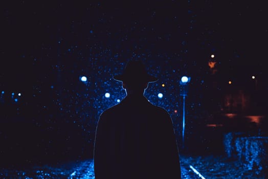 man detective agent in a hat and raincoat at night in a rainy city in the style of film noir