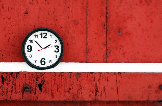 Clocks on a red metal background with free space