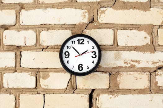 Clocks on a brick wall with free space