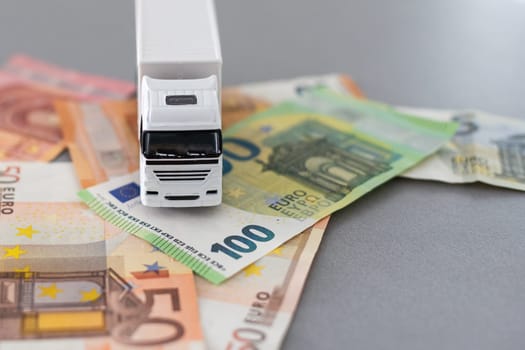 white toy truck on euro banknotes. concept for logistics, transportation and and finance. High quality photo