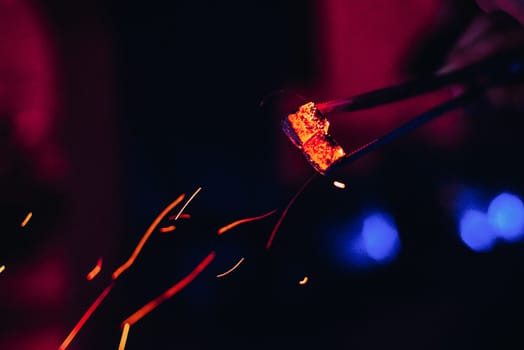 hot coals and red sparks for Shisha with blurred background