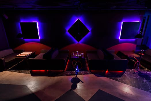 traditional lounge with a hookah in Asia with a beautiful dark, with glow design interiors