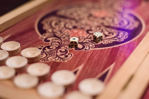 backgammon white game dice for gambling in a casino with blurred background