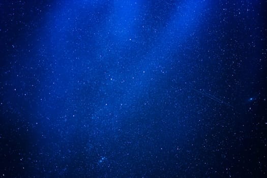 abstract blue background of stars in the night sky with the milky way