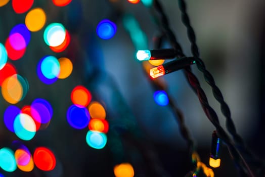 lights Christmas garland with colorful blurred bokeh on the background
