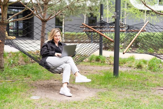 woman with laptop in hammock. High quality photo