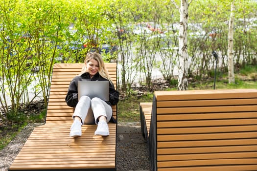 Young business woman working at laptop in the city. High quality photo