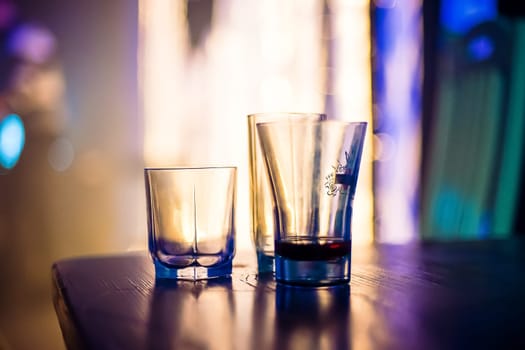empty glasses of vodka at a party in a nightclub