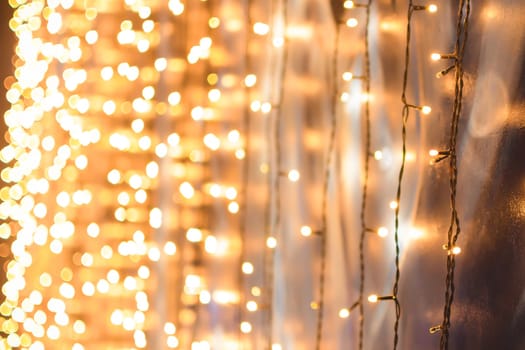 Christmas garland hanging on the wall, with beautiful Golden bokeh