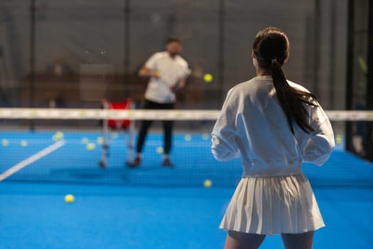 Young Girls Is Playing Padel on an Court.. High quality photo