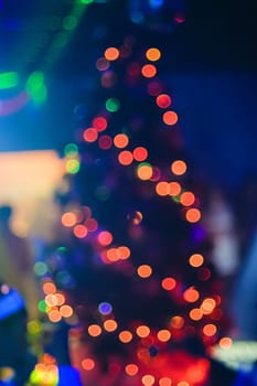 Christmas tree out of focus, colorful background bokeh