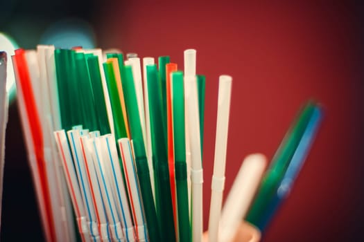 many colorful plastic straws for drinks close up