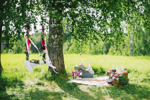 wedding decor outdoors flowers and a swing in summer Sunny day