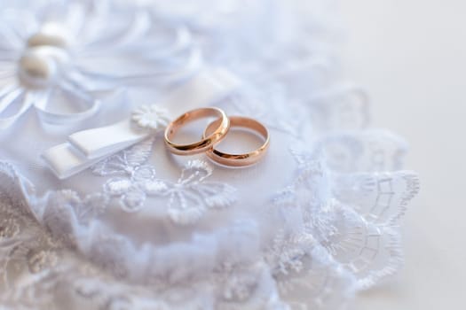 pair of gold wedding rings close-up for a wedding ceremony