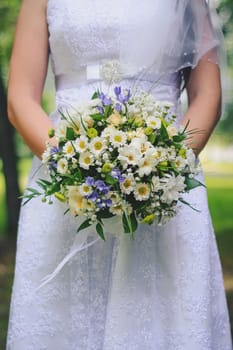beautiful wedding bouquet in the hands of the bride