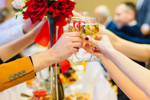 people celebrate and make a toast with glasses of wine in hand