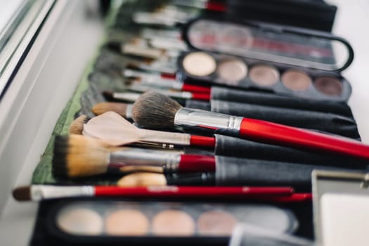 set of brushes and shadows for professional makeup for the eyes and good skin