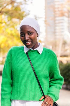 muslim black woman smiling happy looking at camera, concept of tradition and modern lifestyle