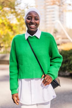 muslim black woman smiling happy looking at camera, concept of tradition and modern lifestyle