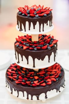 delicious chocolate cake with strawberries and blueberries