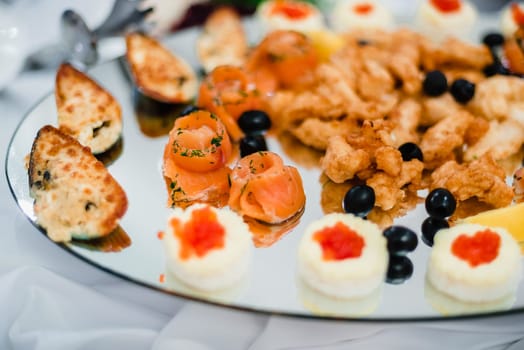 red delicious cooked salmon and mussels in a restaurant on a plate