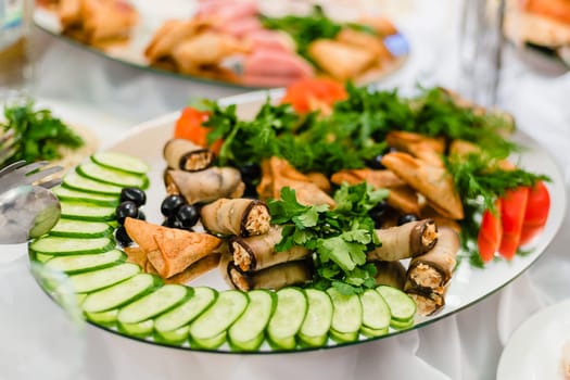 chopped cucumbers, tomatoes, parsley and dill in the restaurant on a platter