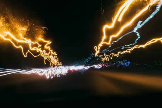 blurred abstract traces of bright night lights of cars