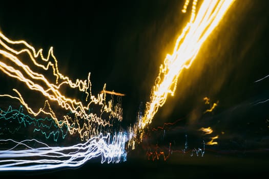 blurred abstract background with colored traces of car lights on a long exposure