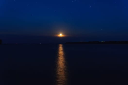 night landscape with moon and stars and moonbeam in river